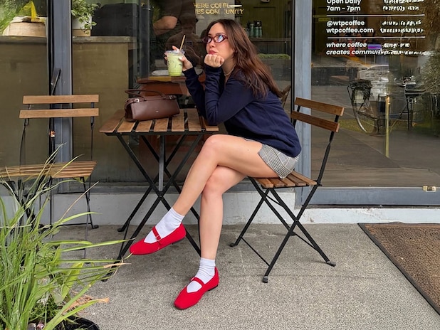 Customer wearing red Margot Mary Jane at cafe