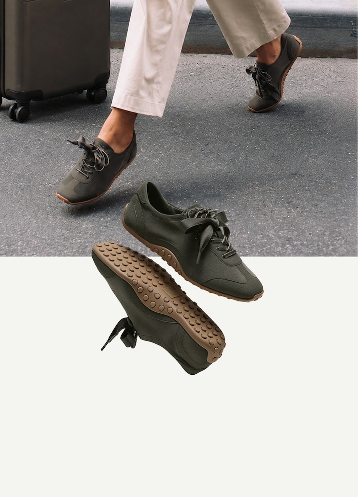 Traveler walking with a suitcase in the Carol recycled velvet Sneakerina