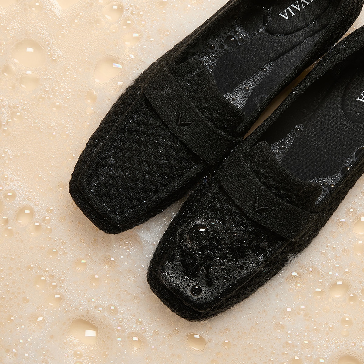 Machine-washable VIVAIA loafers shown in gentle cleansing foam