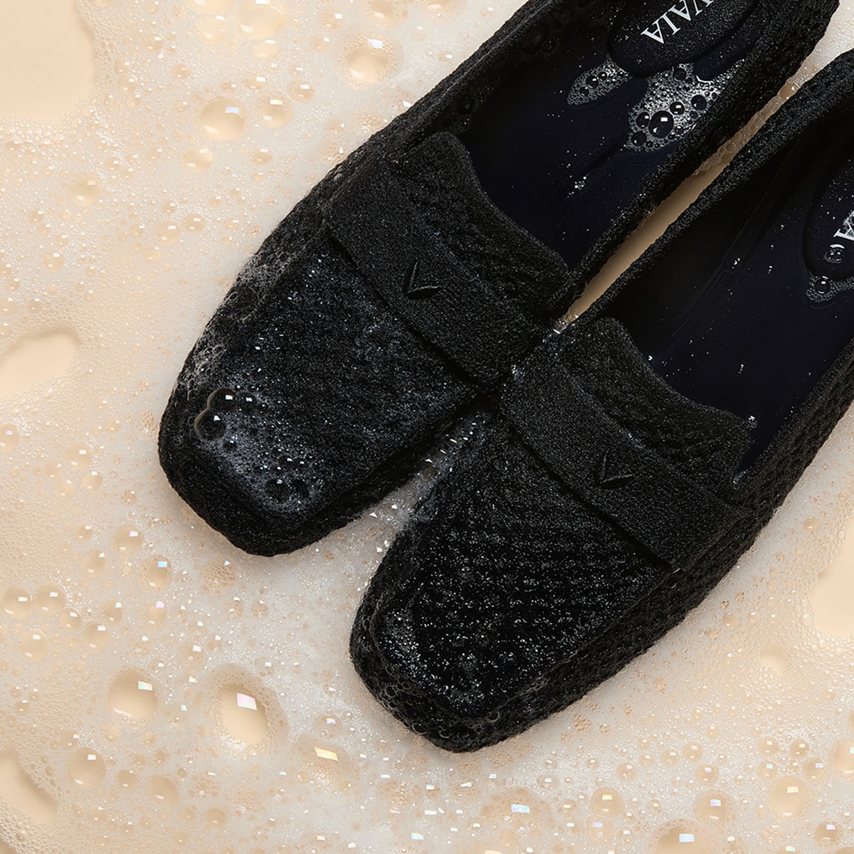 Machine-washable VIVAIA loafers shown in gentle cleansing foam