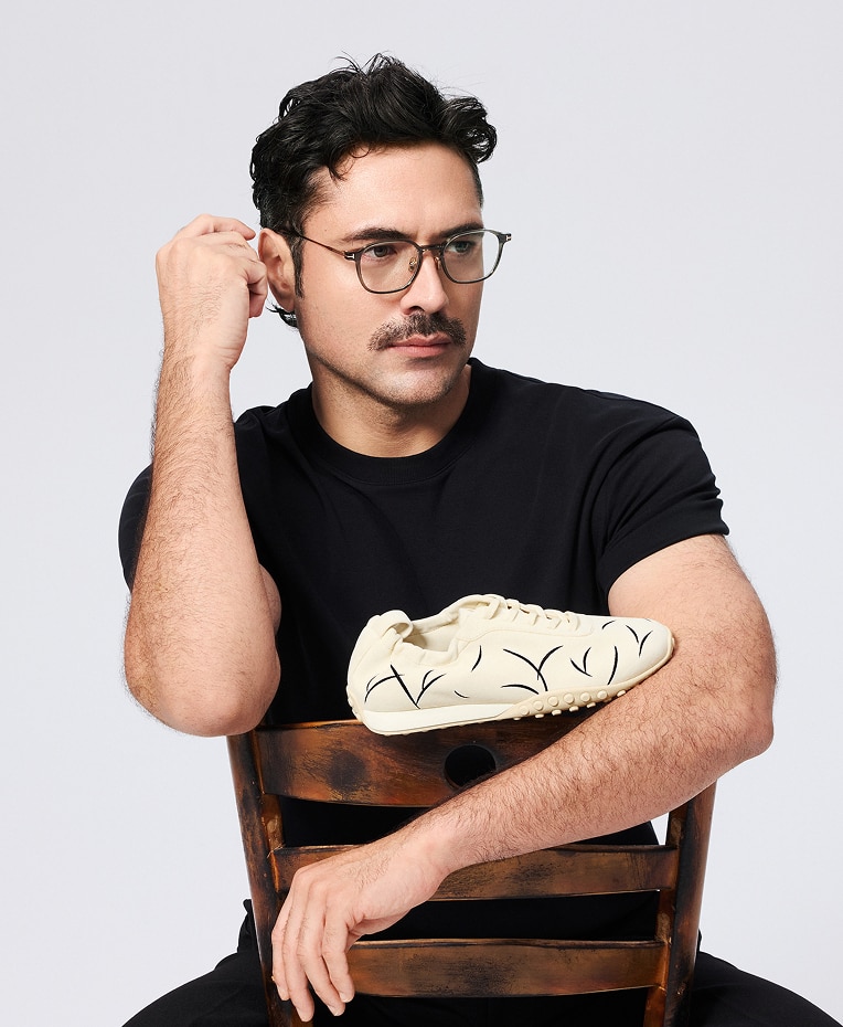 Creative Director Alan Buanne holding a VIVAIA shoe