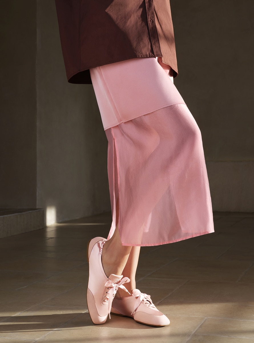 beige dress pink shoes Woman Stands in a Light Pink Knee-length Dress, Seen from Behind. Her Hair is Tied Back, and she Wears Flat Beige Shoes on a Plain Stock Image