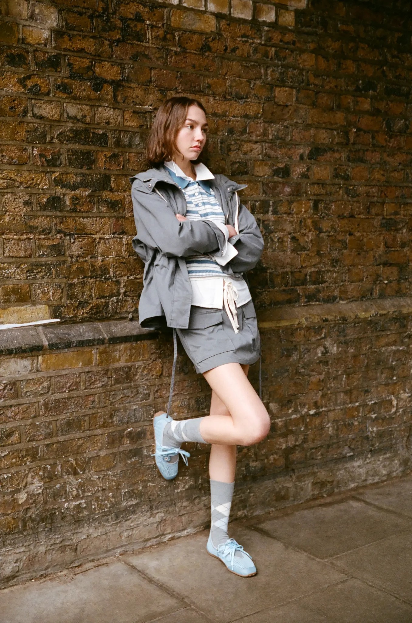 KOL wearing blue Hybrid Mesh Mary Janes against brick wall