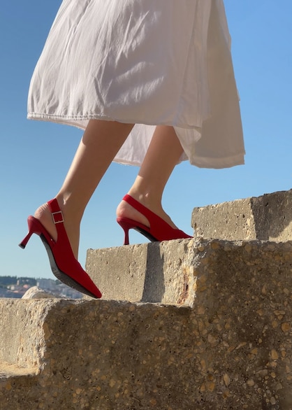 Luisa wearing Addison red heels in Santorini