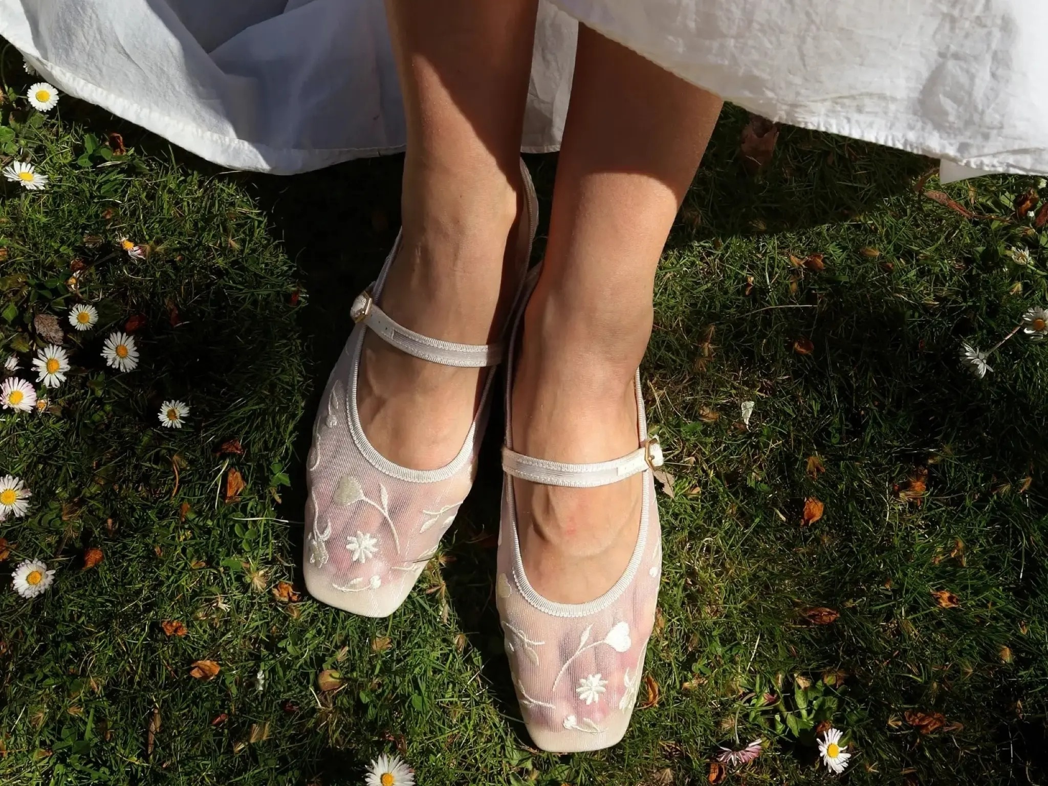 Floral embroidered Mary Jane shoes on grass