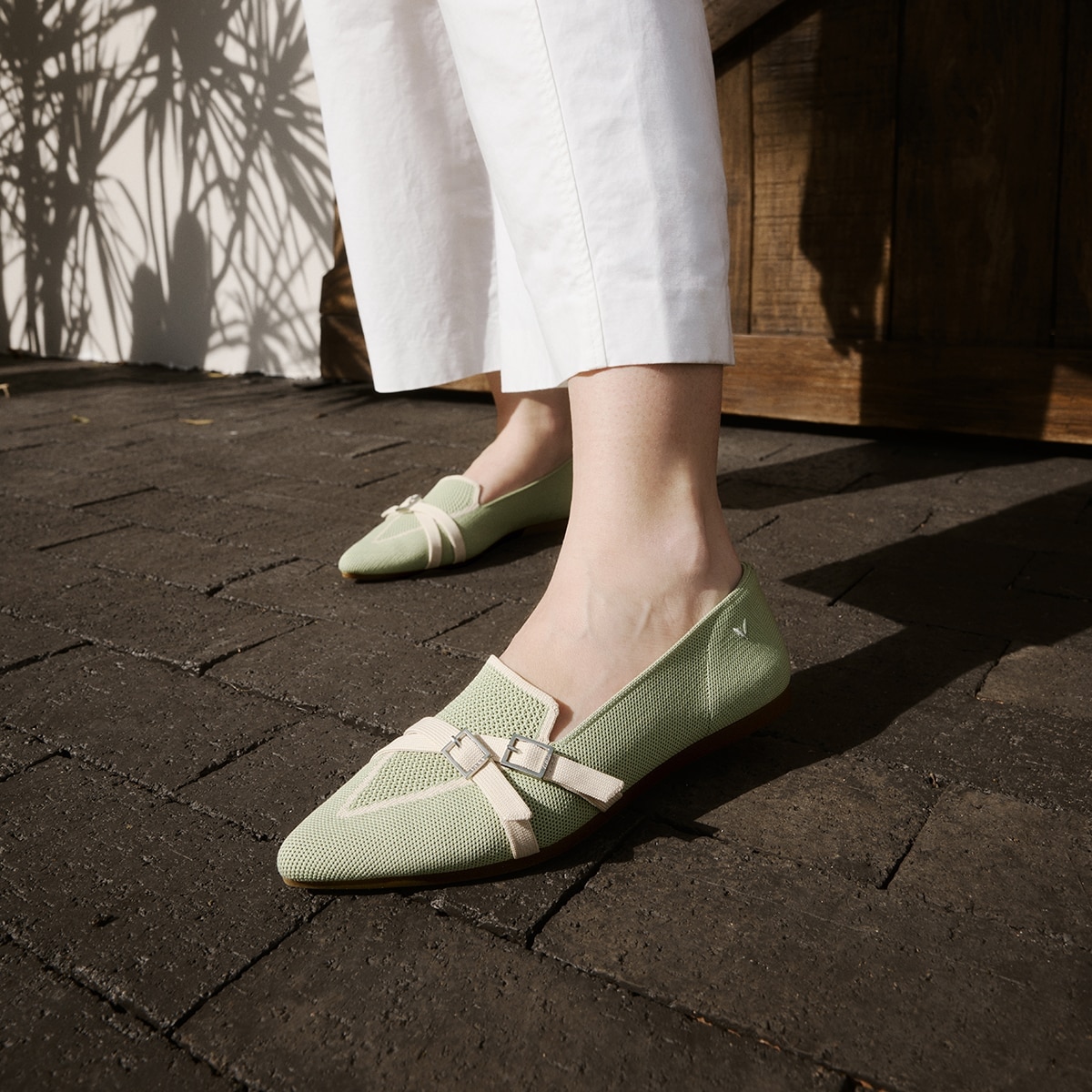 Model wearing VIVAIA Marvis green crisscross loafers outdoors