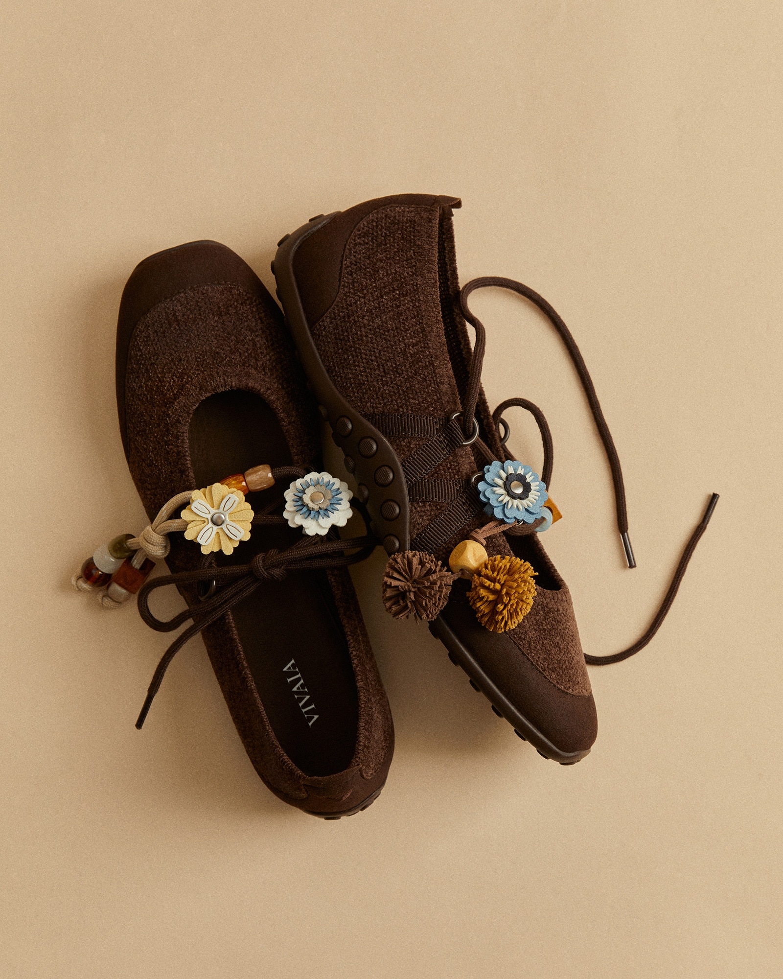 Brown VIVAIA sneakers styled with autumn flower charms, cords and beads