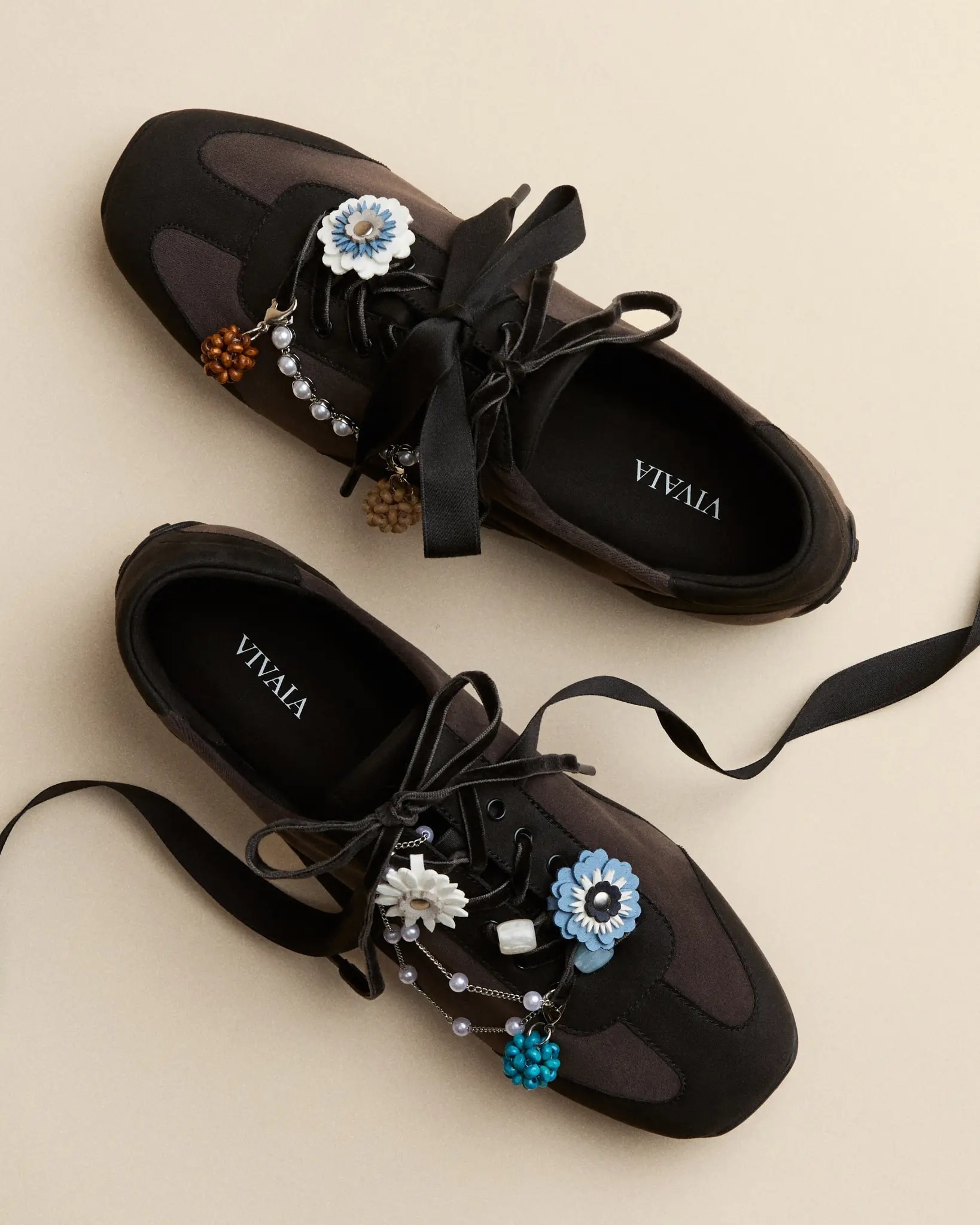 Black VIVAIA shoes styled with blue flower charms, pearl chains and black ribbons