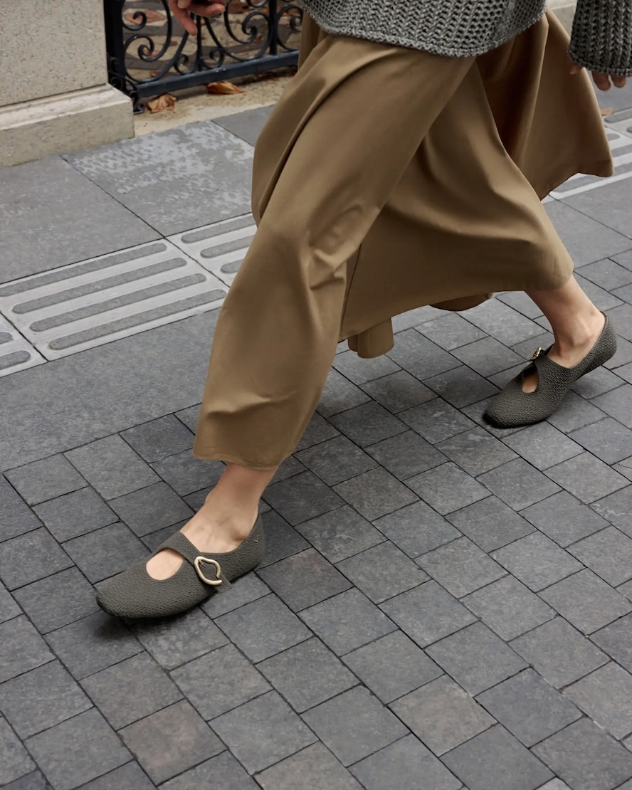 Jovin worn while walking through an early-fall city street
